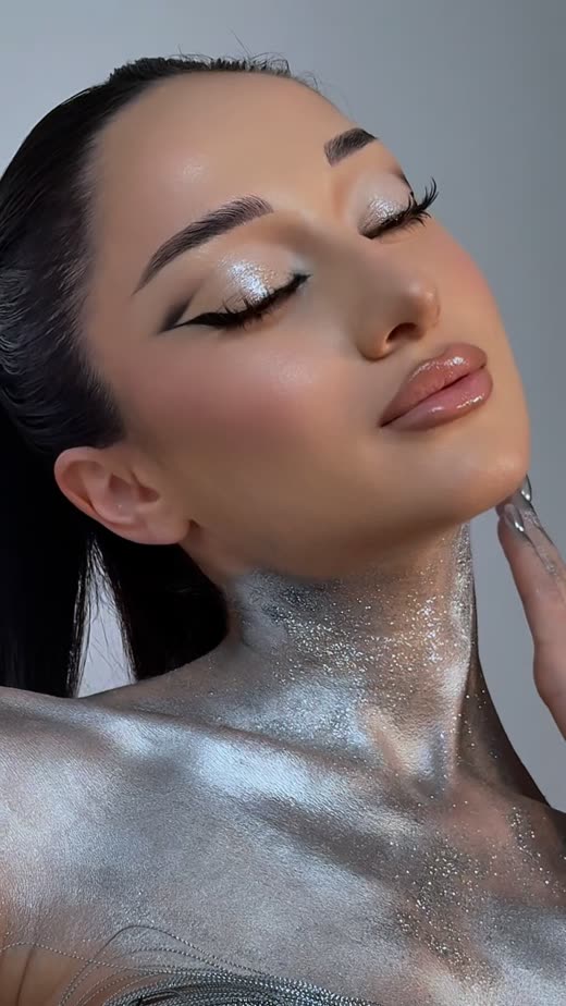 Editorial makeup with silver shimmer and graphic liner